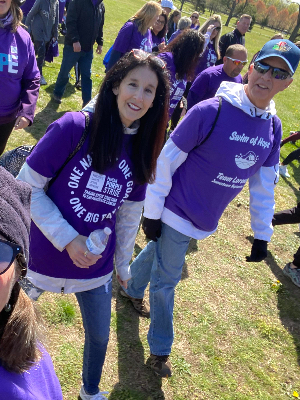 Keith Ryan, right, and his wife, Elena, walk in the Purple Stride event in Providence on April 30, 2022.
