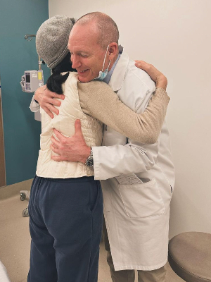 Lingmei (survivor) hugging Dr. Purcell (CMO @ Fred Hutch) after she was declared of full remission