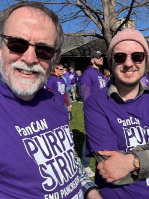 Two members of the JoWalkers, wait to walk in the PanCan Purple Stride walk this orodd