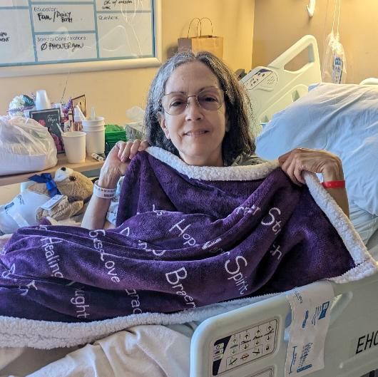 Jennifer showing off her new blanket in her favorite color: PURPLE